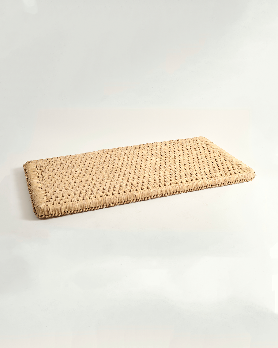 Rectangular woven mat on a white background