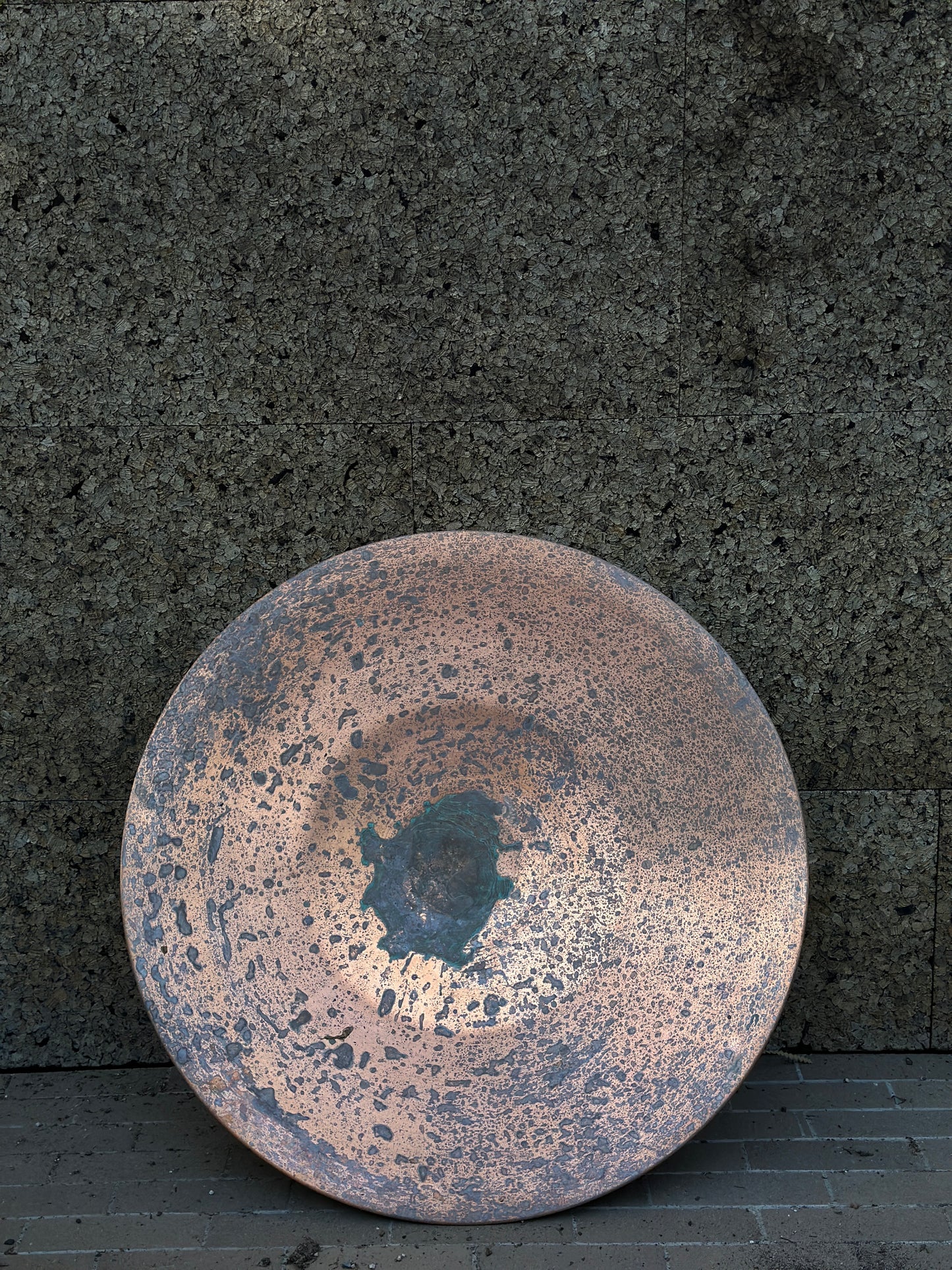 Round stone disc on a textured dark background