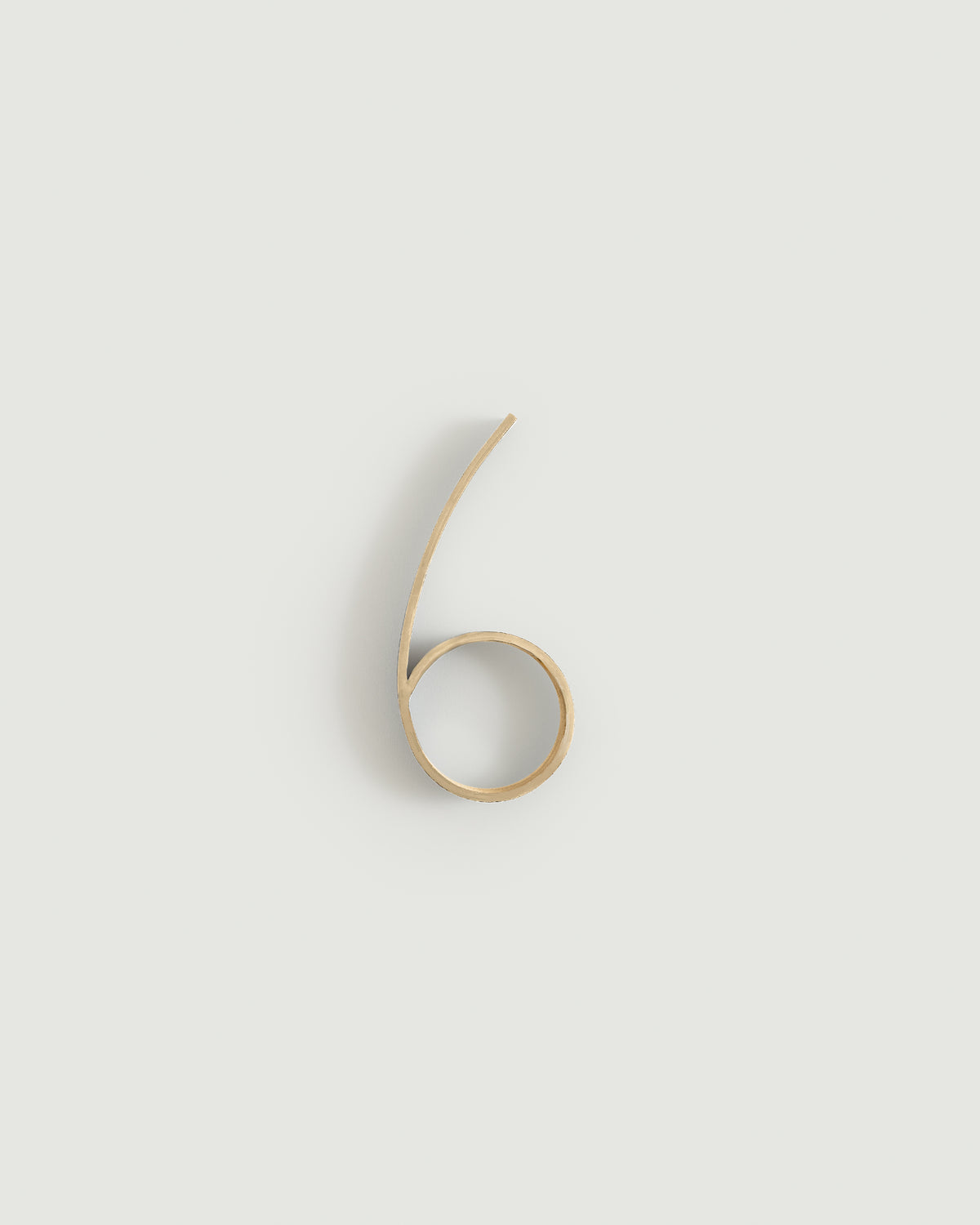 Raw brass house number six