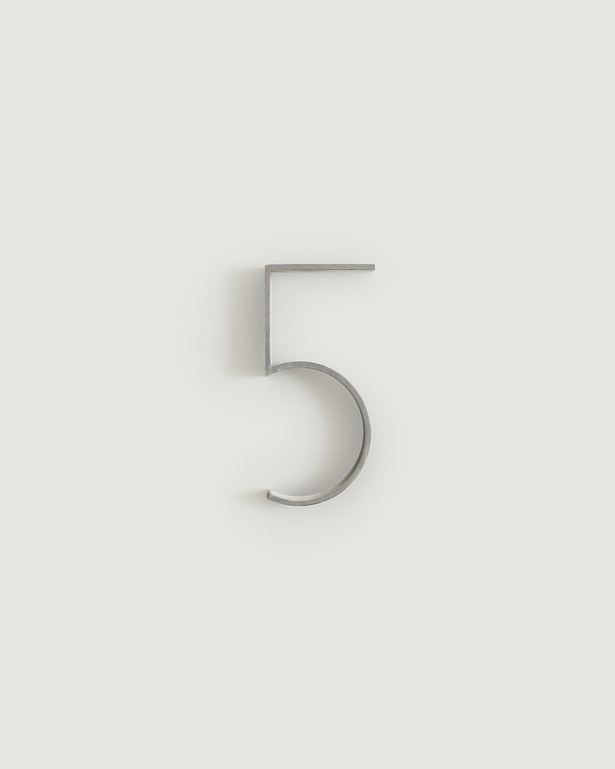 Worn silver house number five