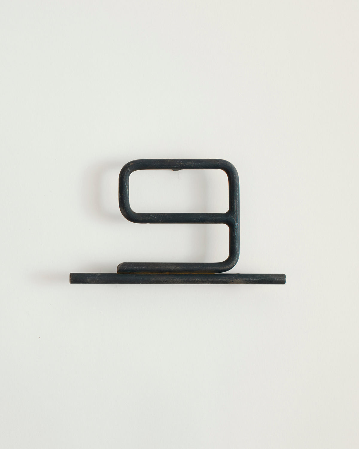 Black house number '9' on a white wall