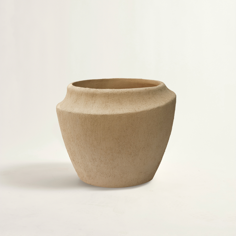 beige ceramic pot on a light beige background