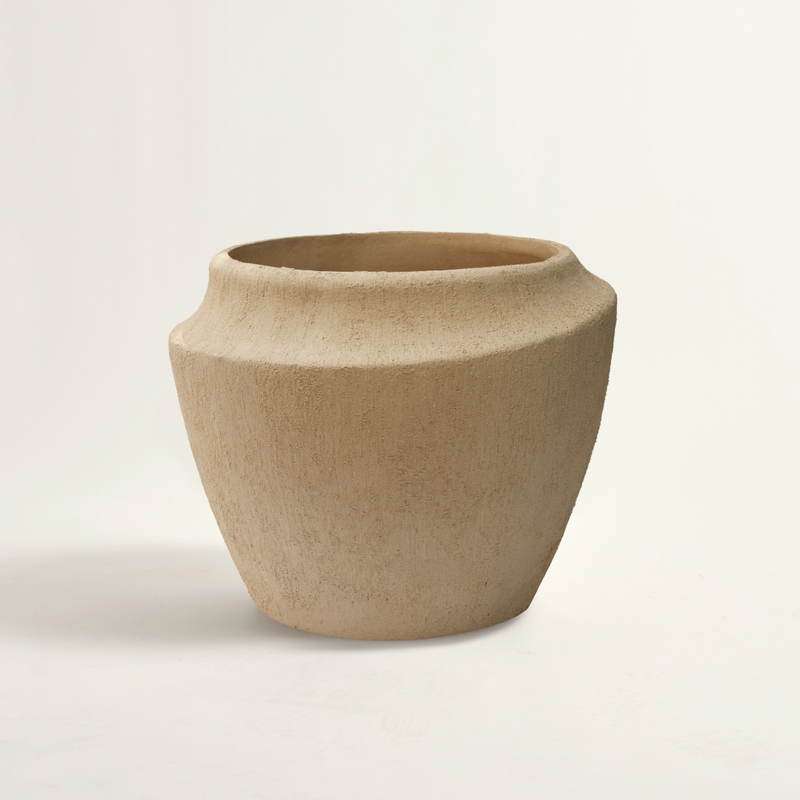 beige ceramic pot on a light beige background