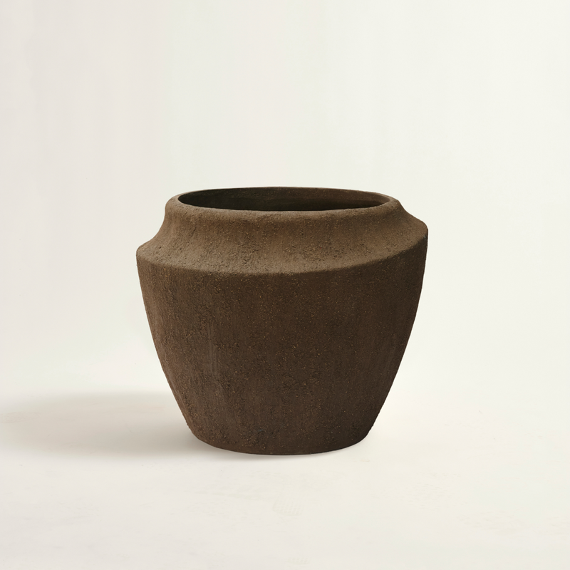Brown ceramic pot on a beige background