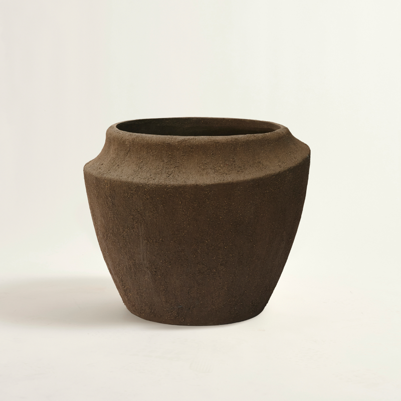 Brown ceramic pot on a beige background