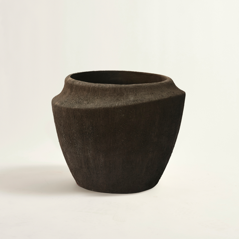 Brown ceramic vase on a light beige background