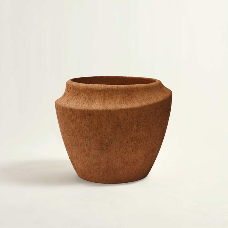 Brown ceramic pot on a light beige background