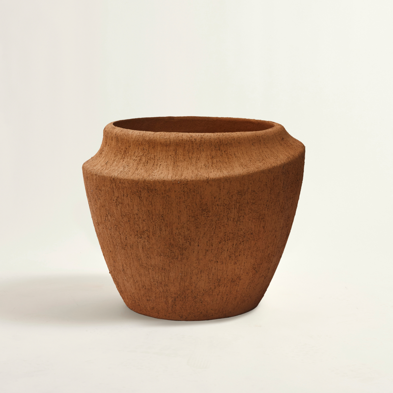 Brown ceramic vase on a beige background