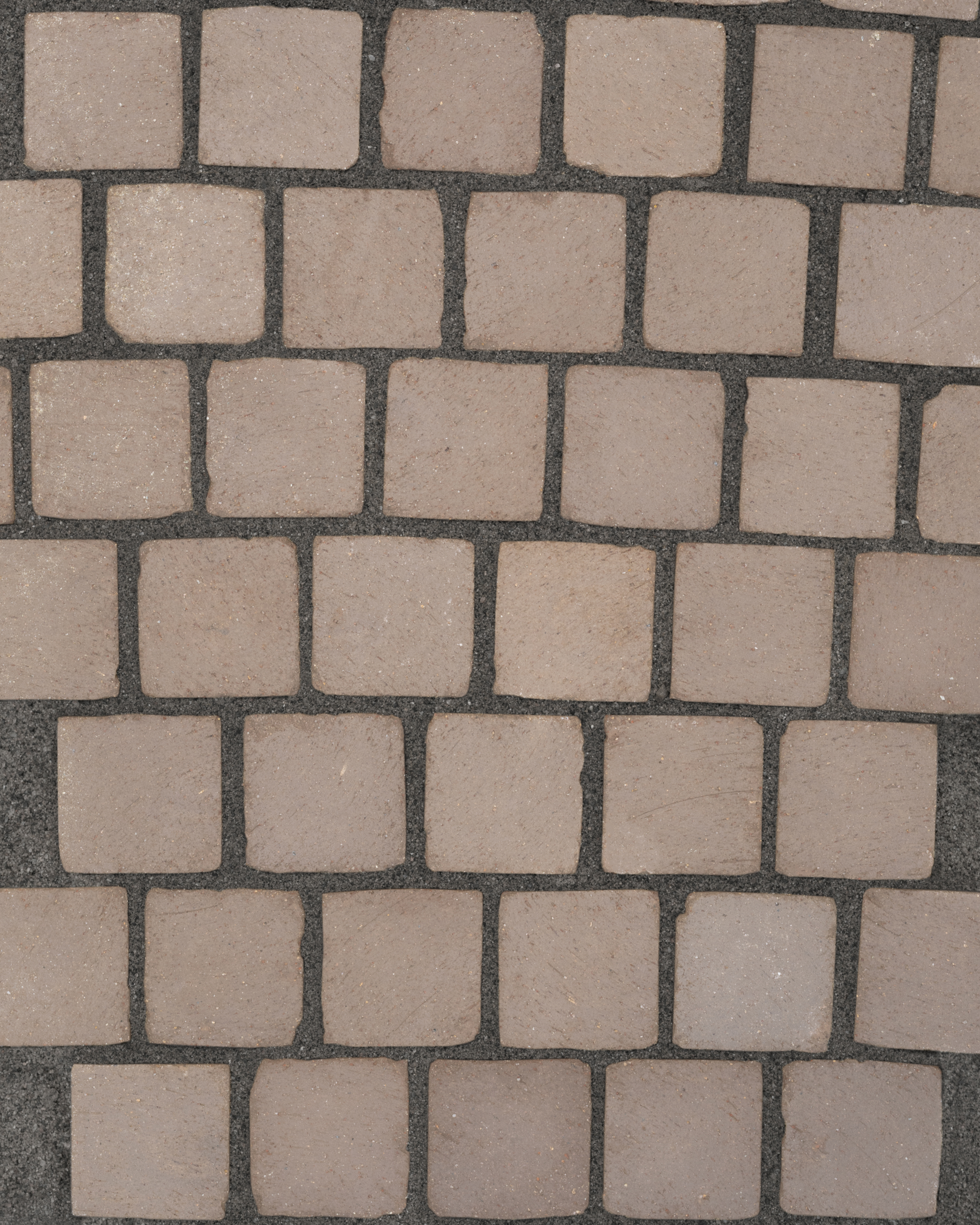 Pattern of square stone tiles on a dark background
