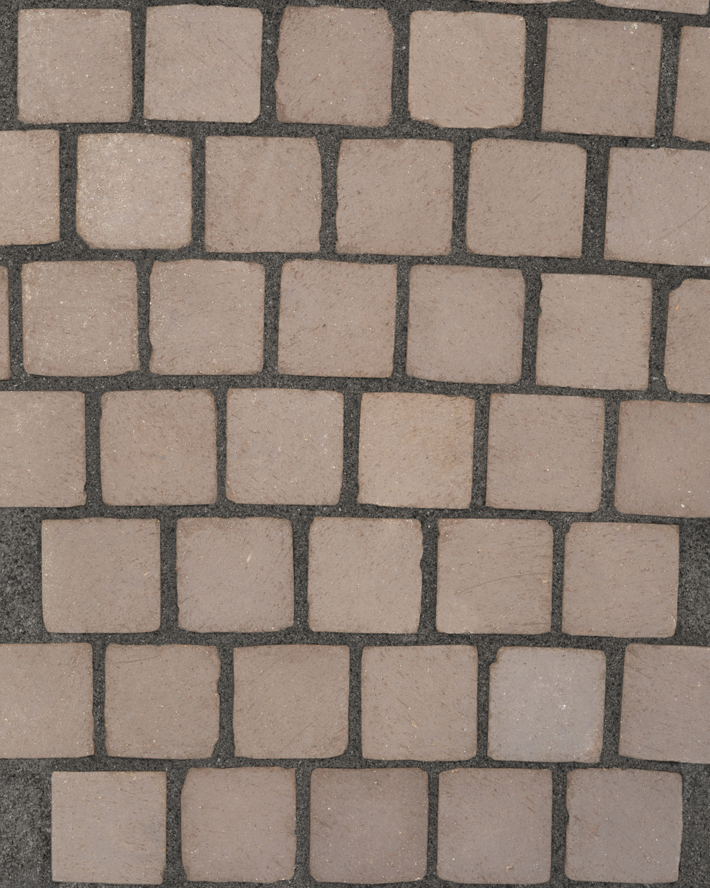 Pattern of square stone tiles on a dark background