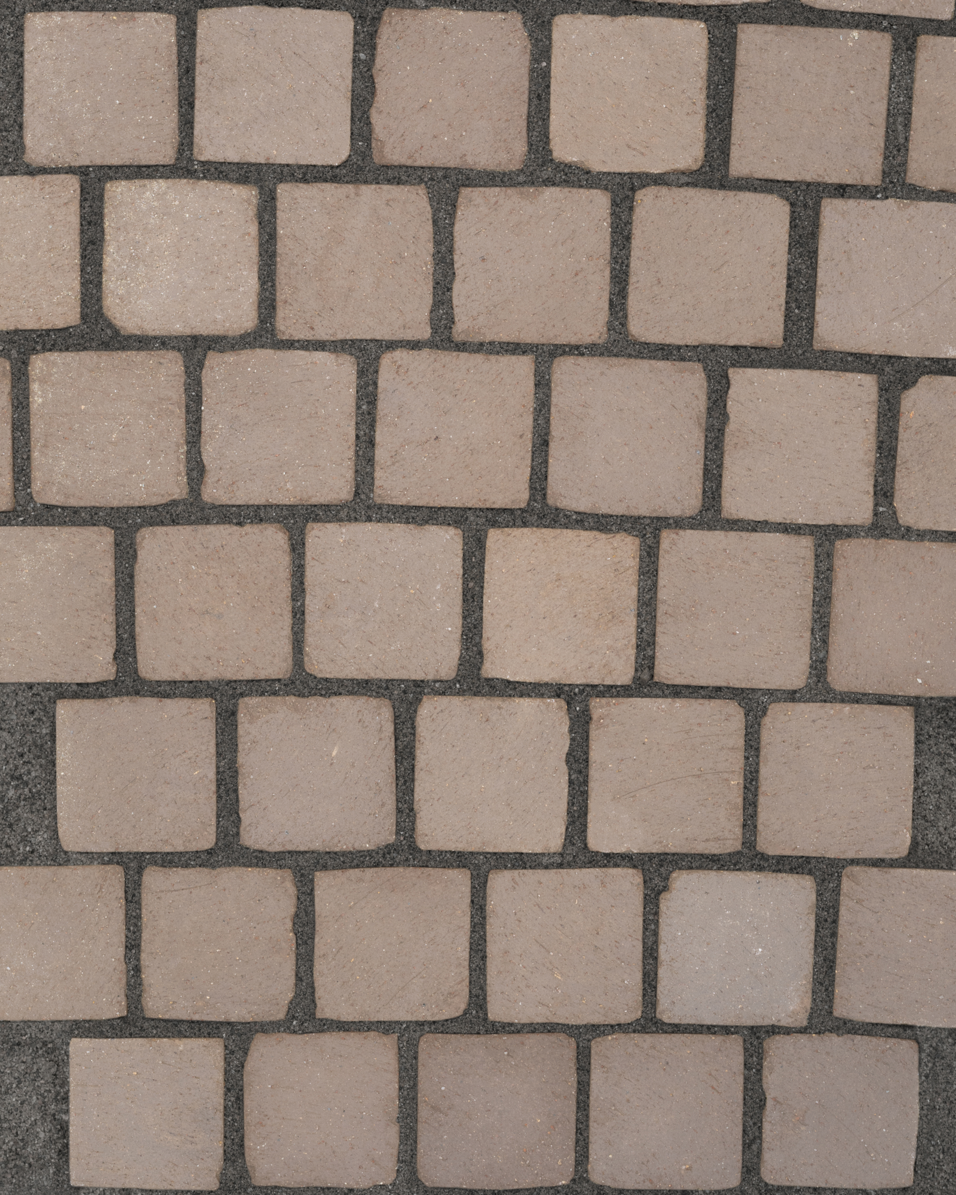 Pattern of square stone tiles on a dark background