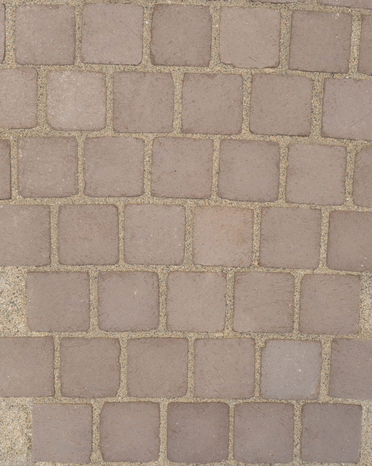 Pattern of square stone tiles in a grid formation