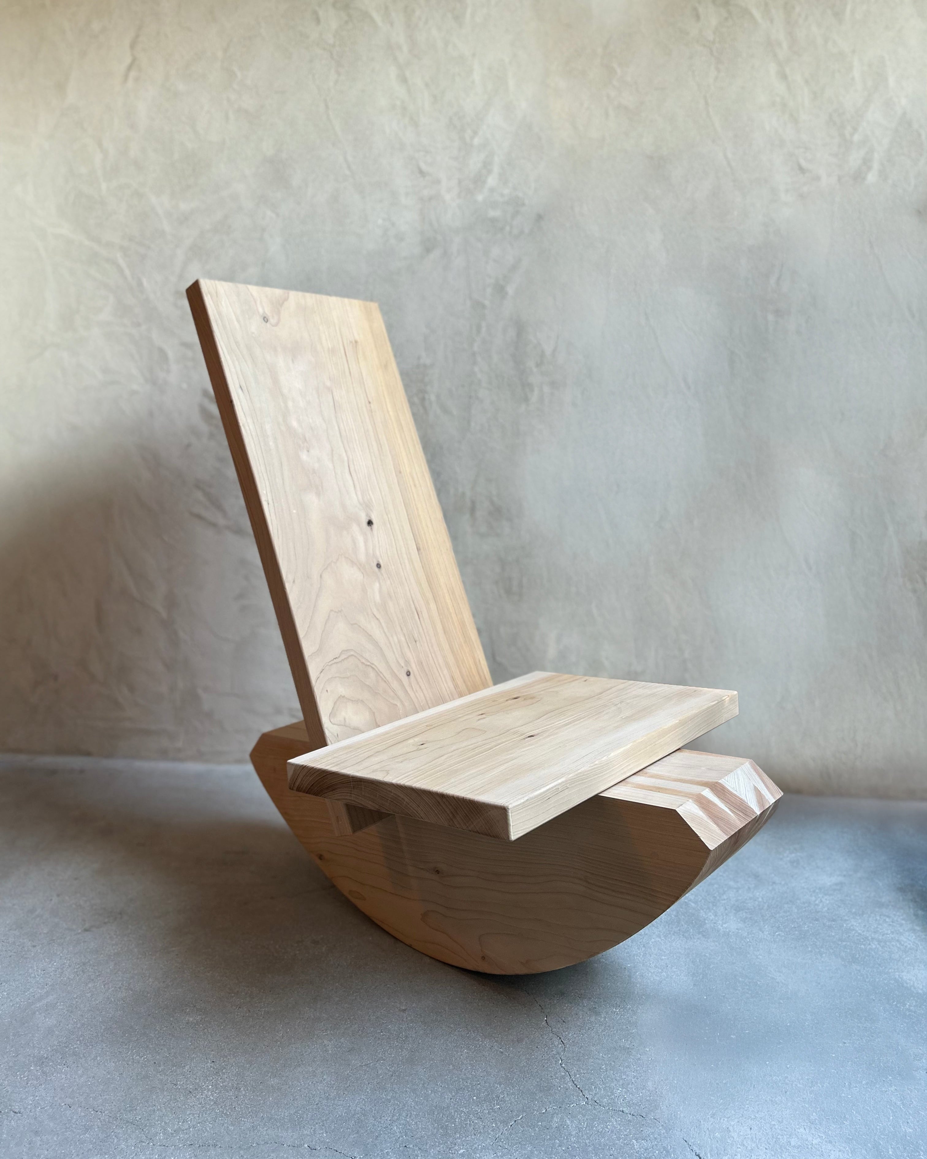 Wooden chair against a plain wall