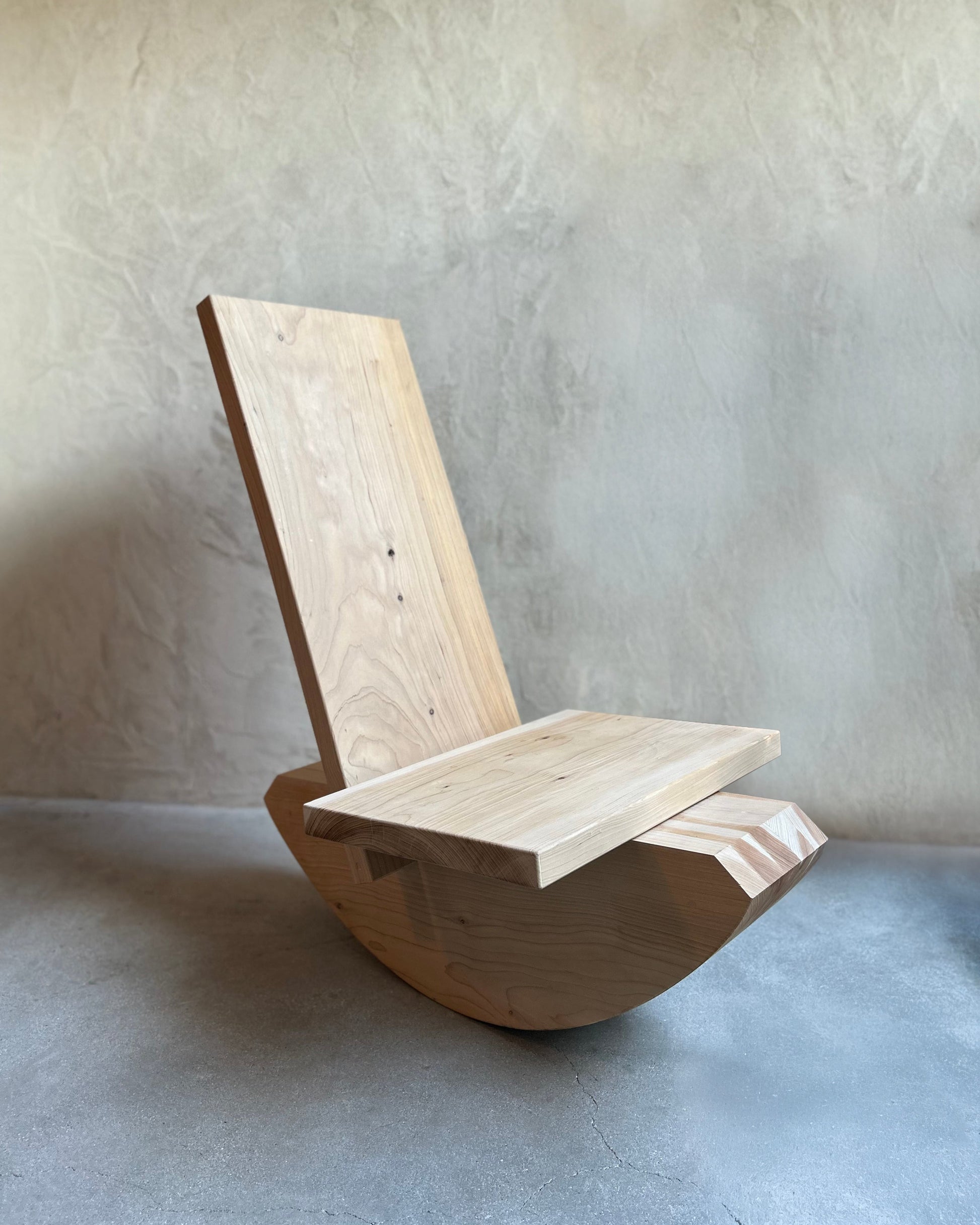 Wooden chair against a plain wall