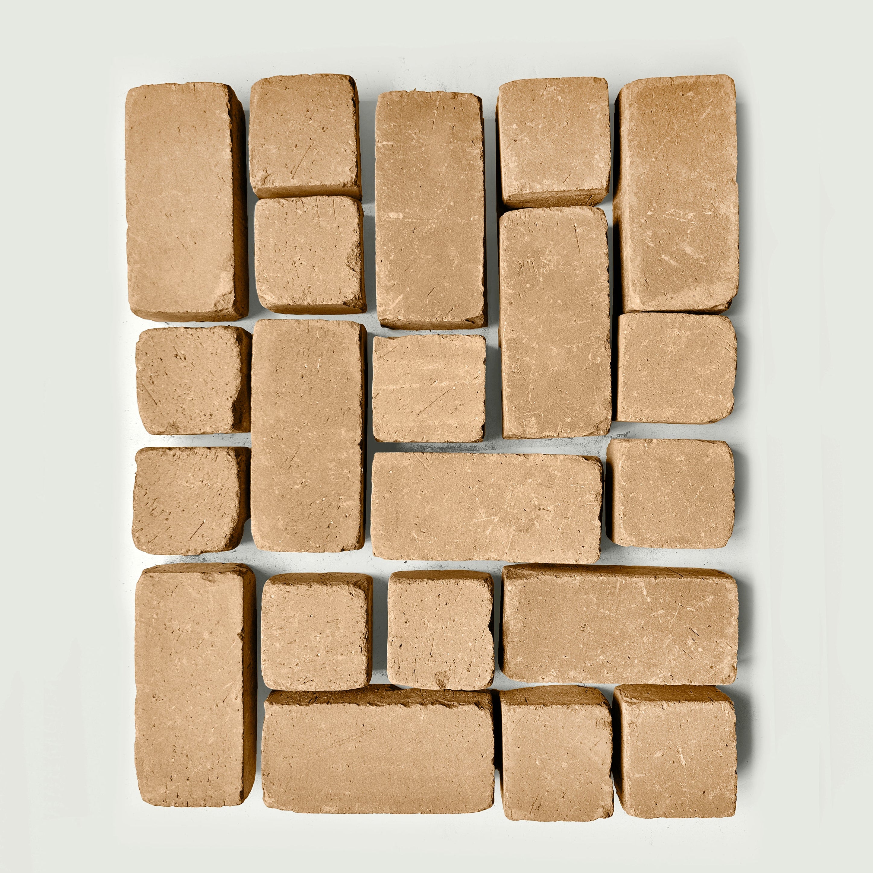 Arrangement of tan pavers s on a white gray background