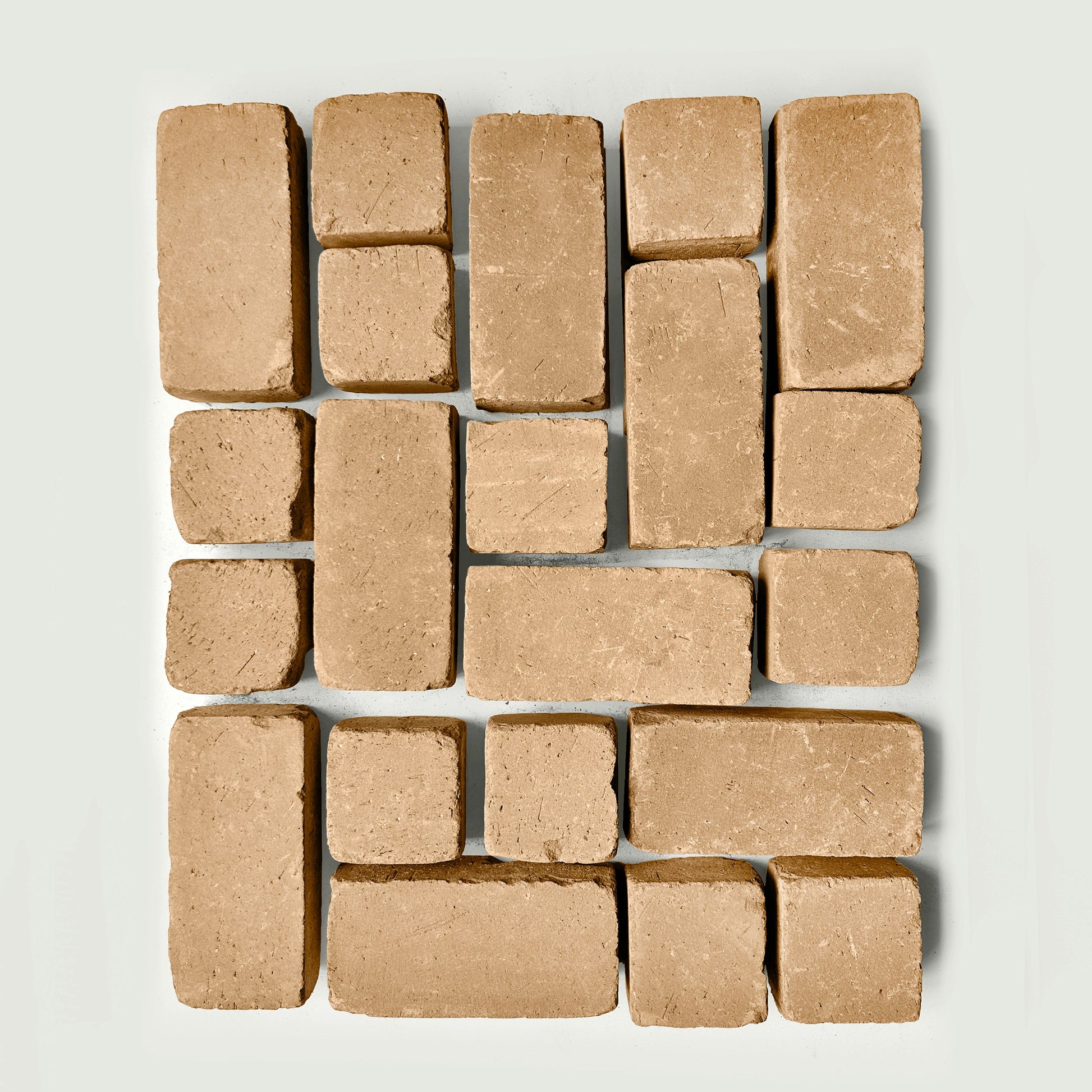 Arrangement of tan pavers s on a white gray background