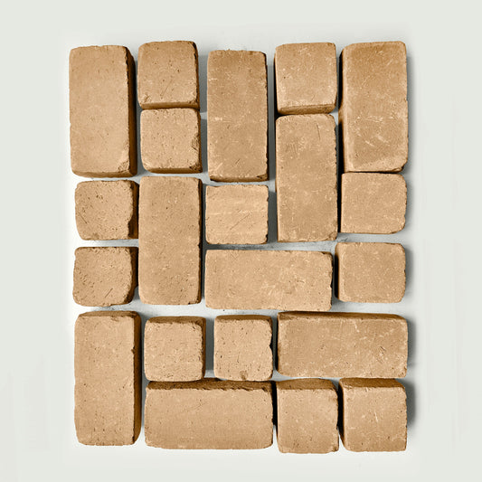 Arrangement of tan pavers s on a white gray background