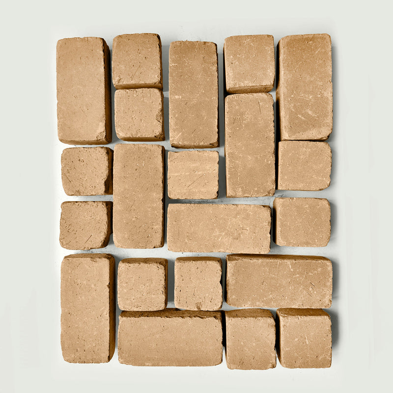 Arrangement of tan pavers s on a white gray background
