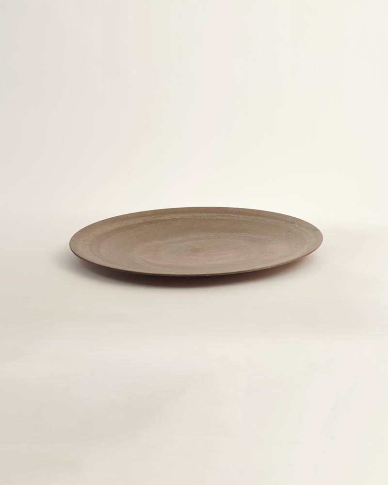 Brown ceramic plate on a light beige background