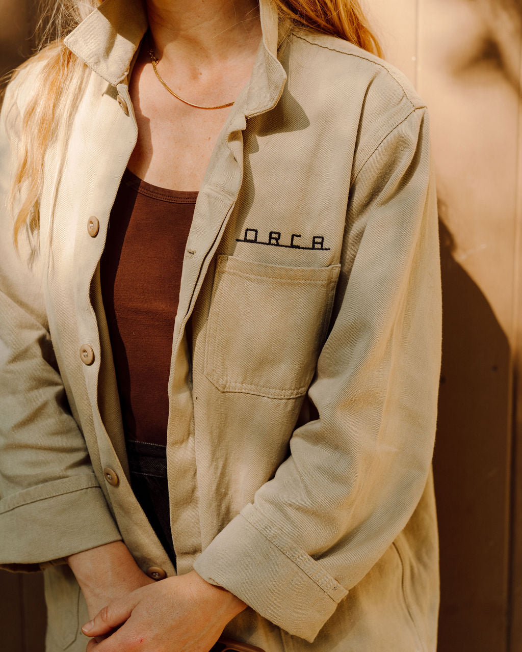 Orca field jacket on model, orca logo above  pocket