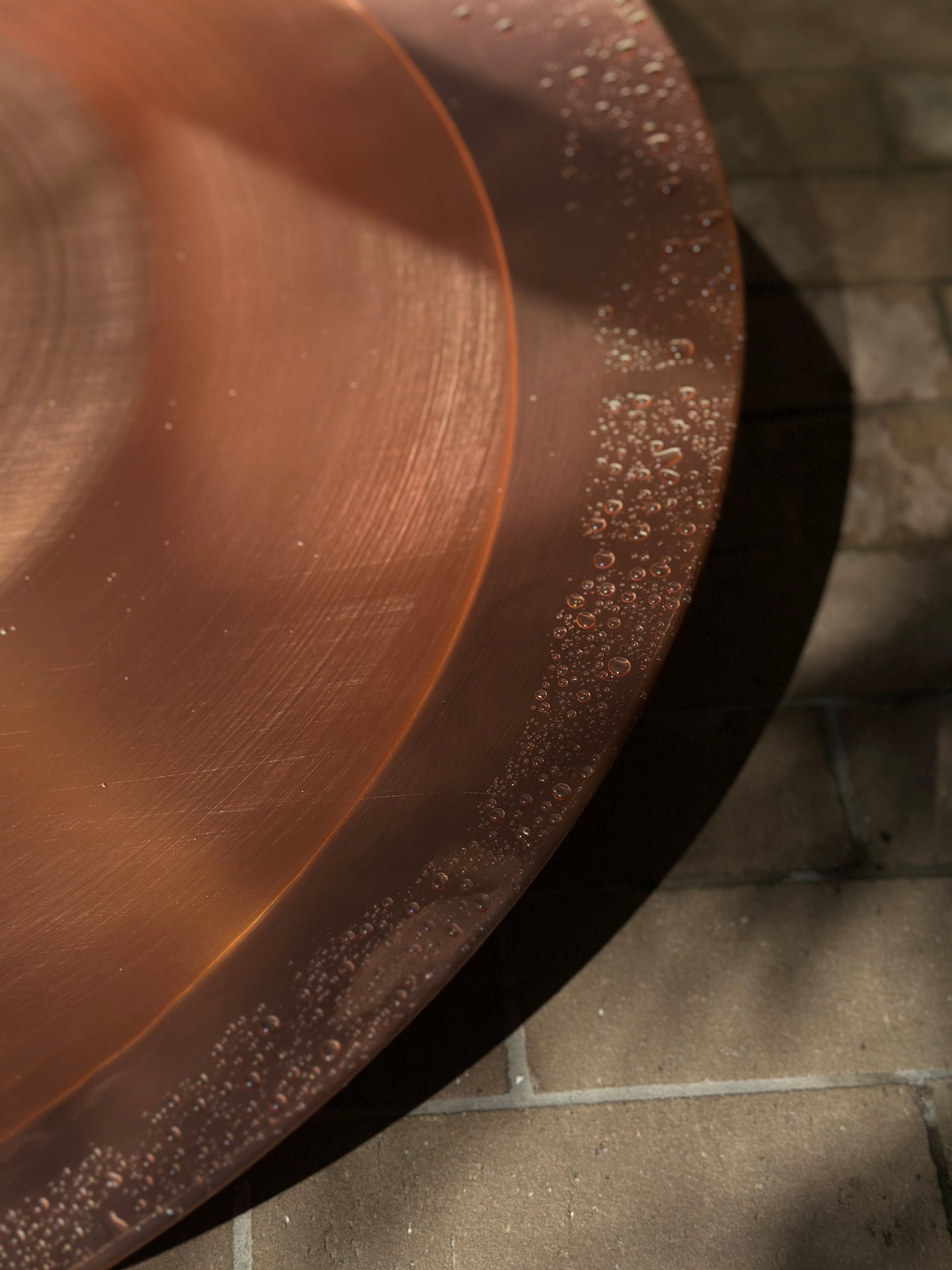 Close-up of a copper bowl on a stone surface