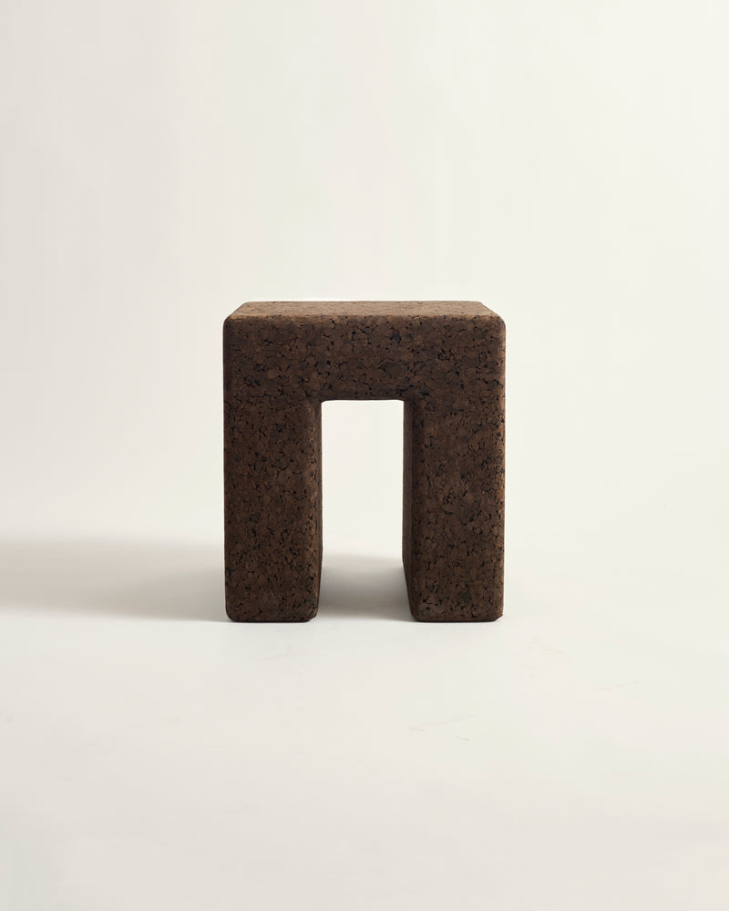 Brown square block with a central cutout on a white background