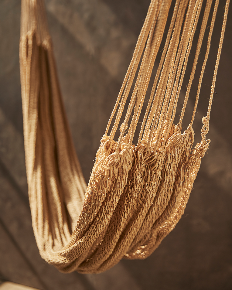 Brown hammock against a brown background