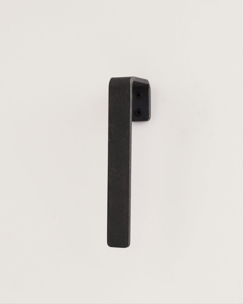 blackened brass gate hardware on white background