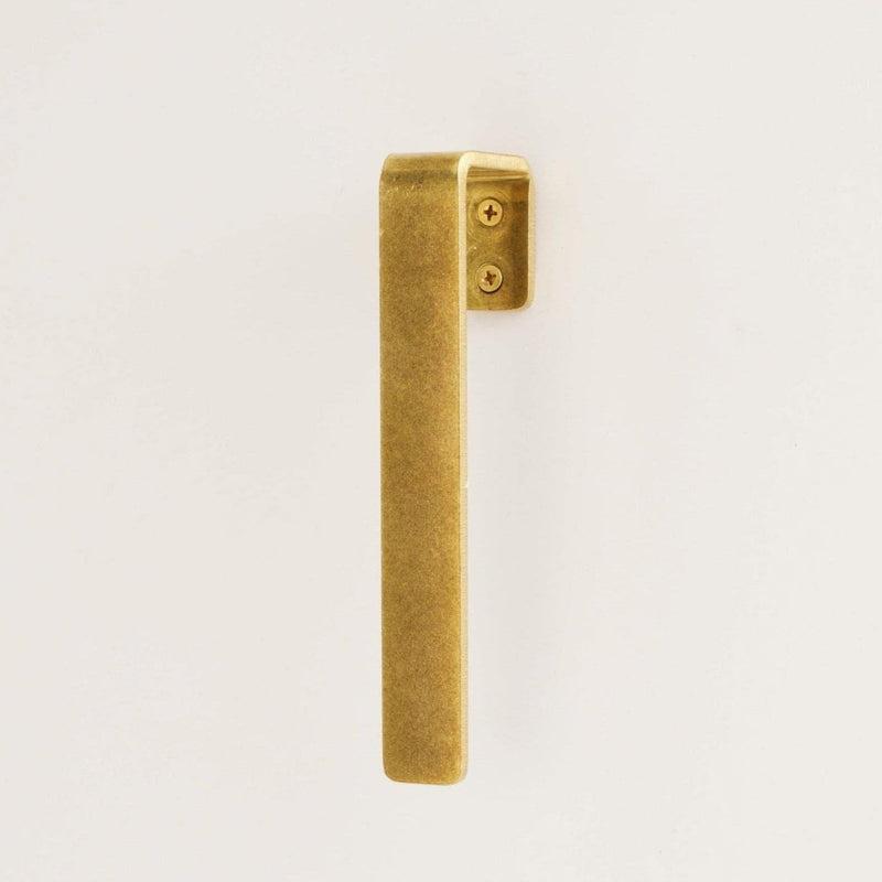 raw brass gate handle n white background