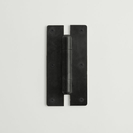 Black metal hinge on a light gray background