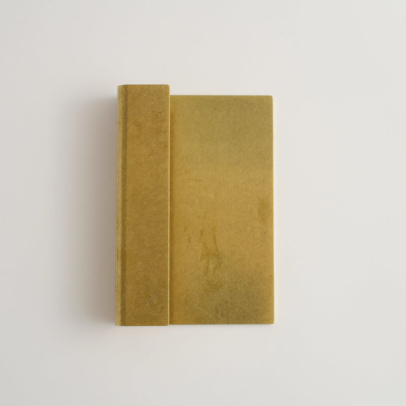 oversized raw brass handle on white background