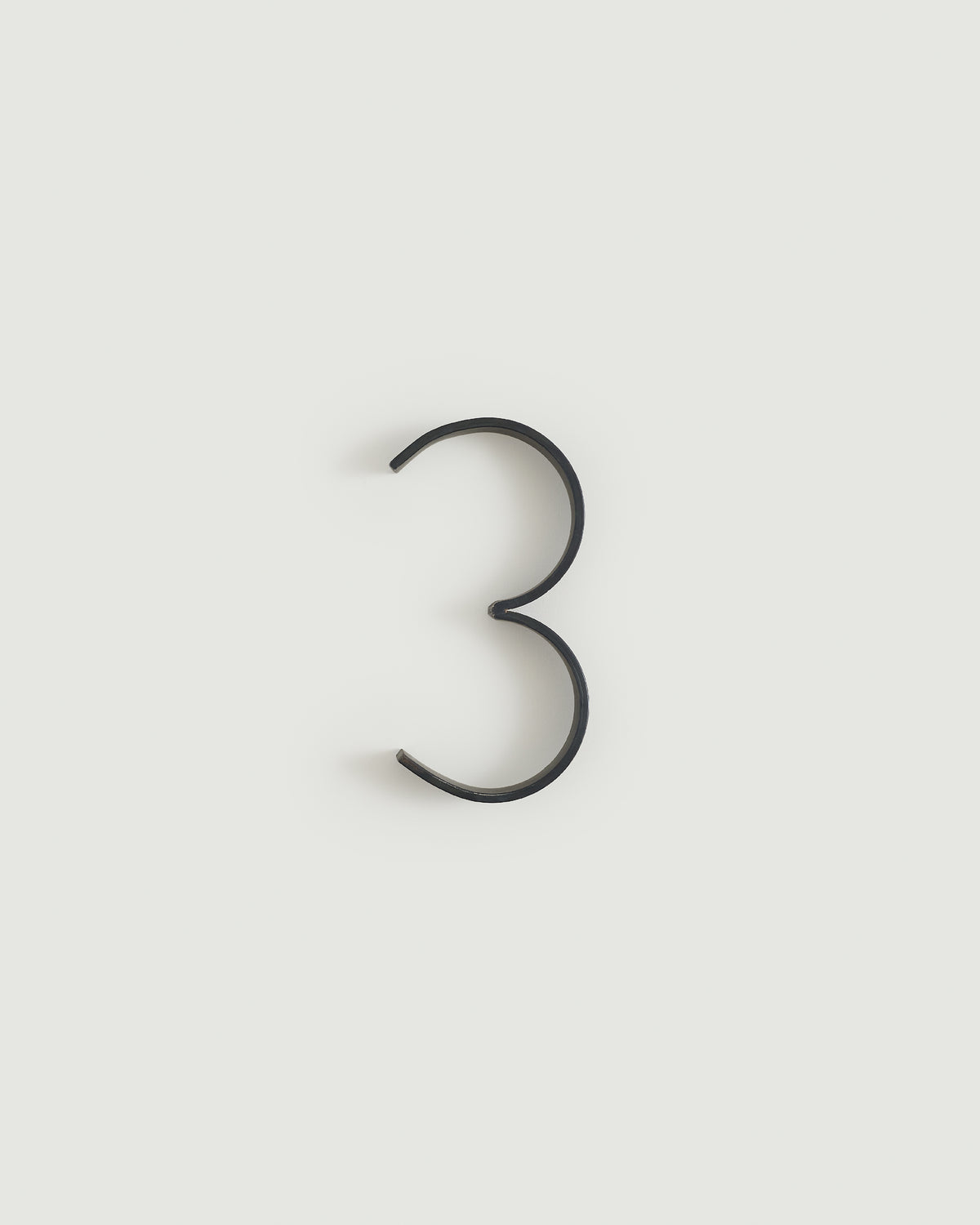 Blacked brass house number three