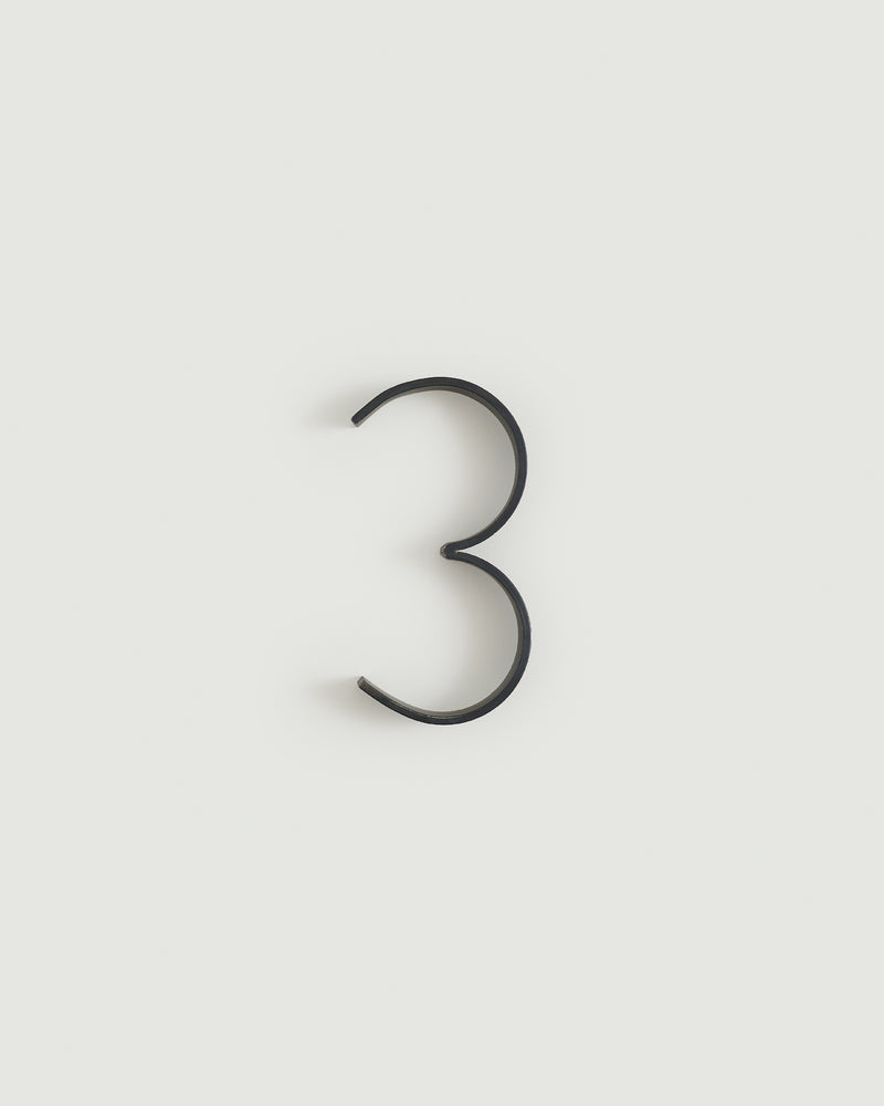 Blacked brass house number three