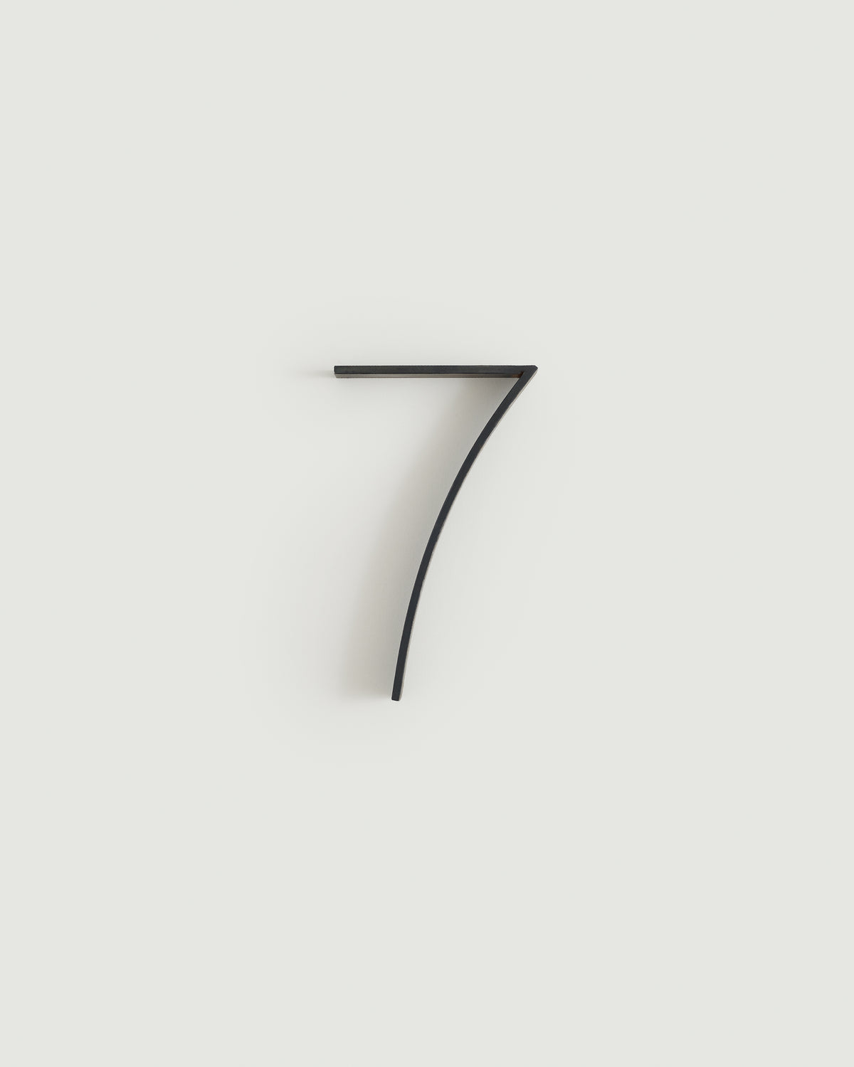 Blacked brass house number seven