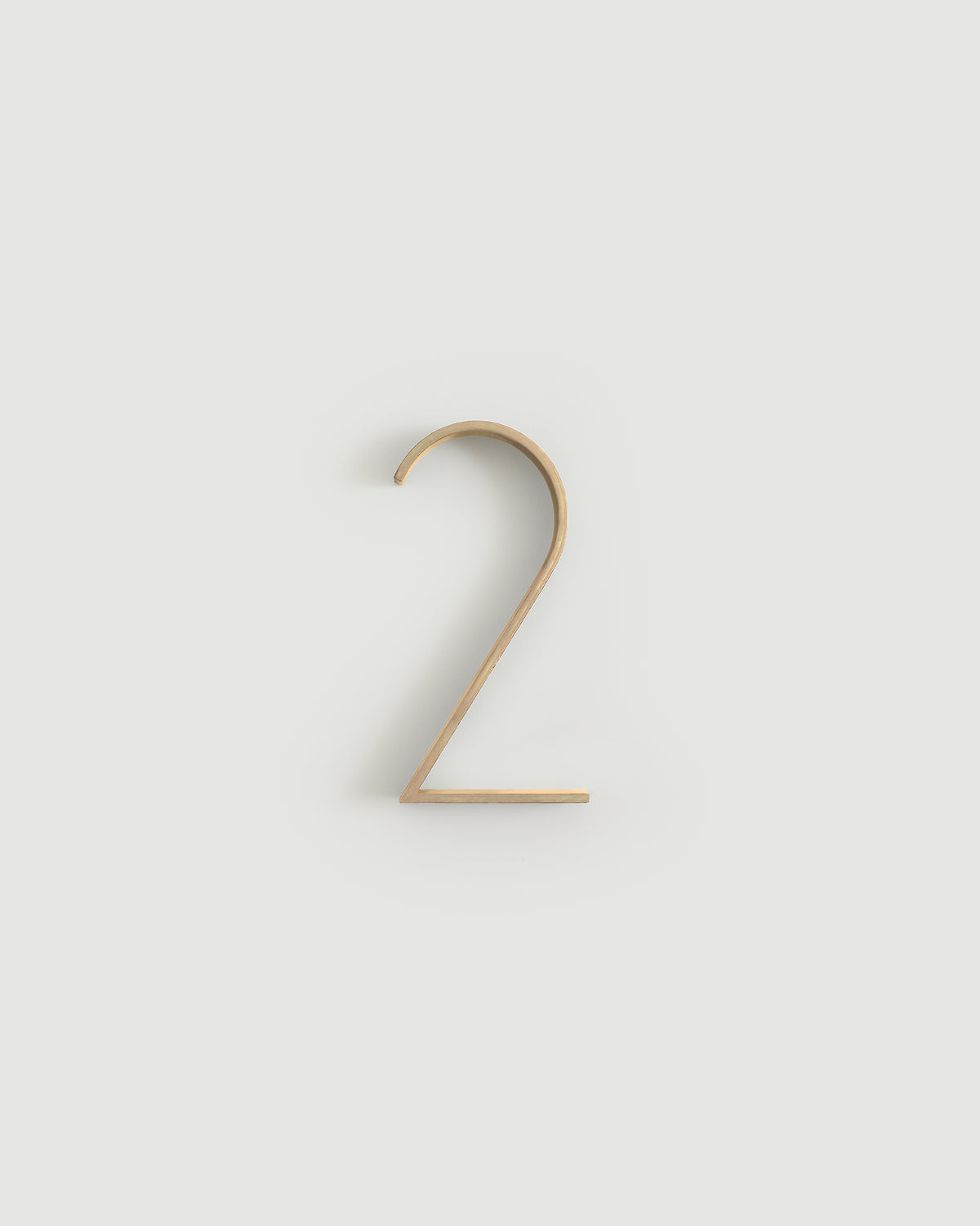 Raw brass house number two