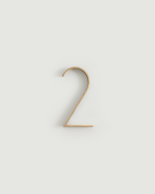 Raw brass house number two