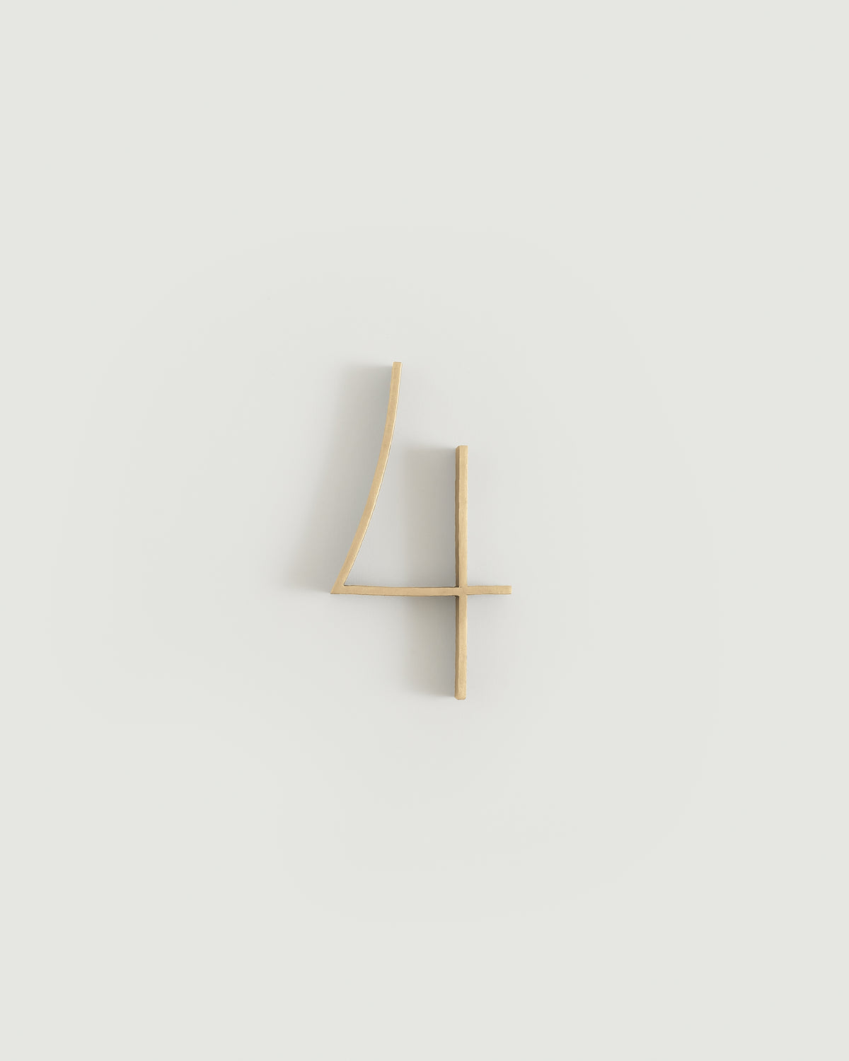 Raw brass house number four