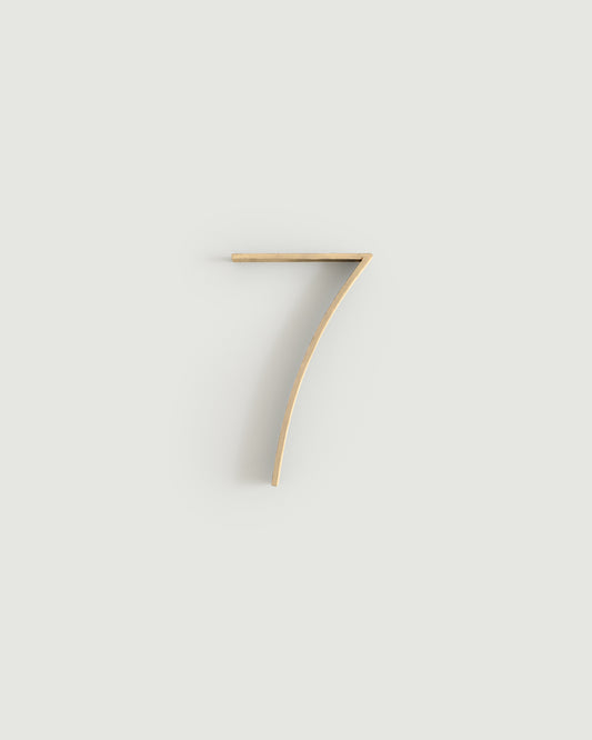Raw brass house number seven