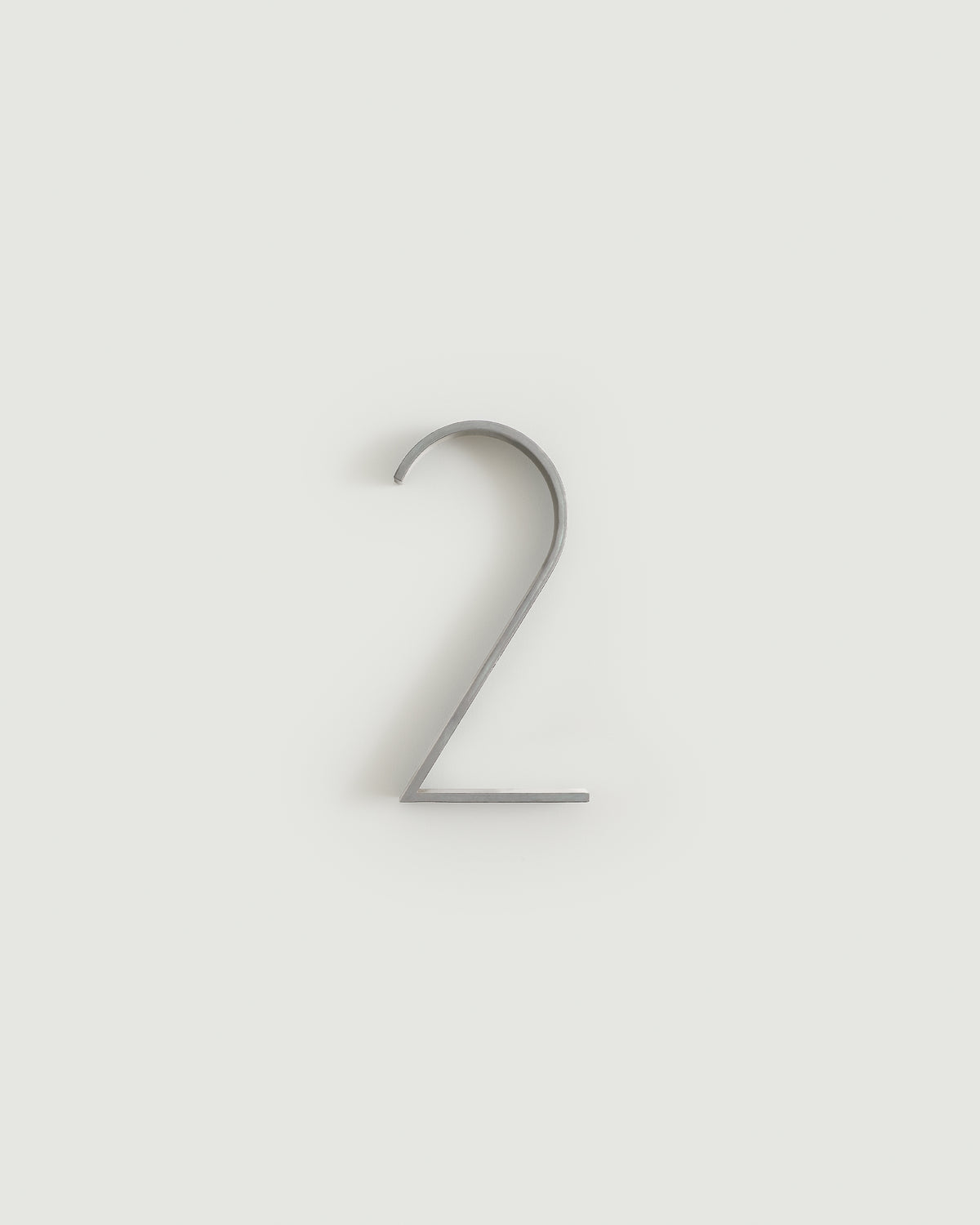 Worn silver house number two