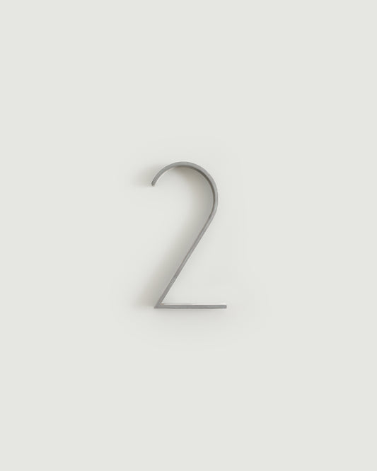 Worn silver house number two