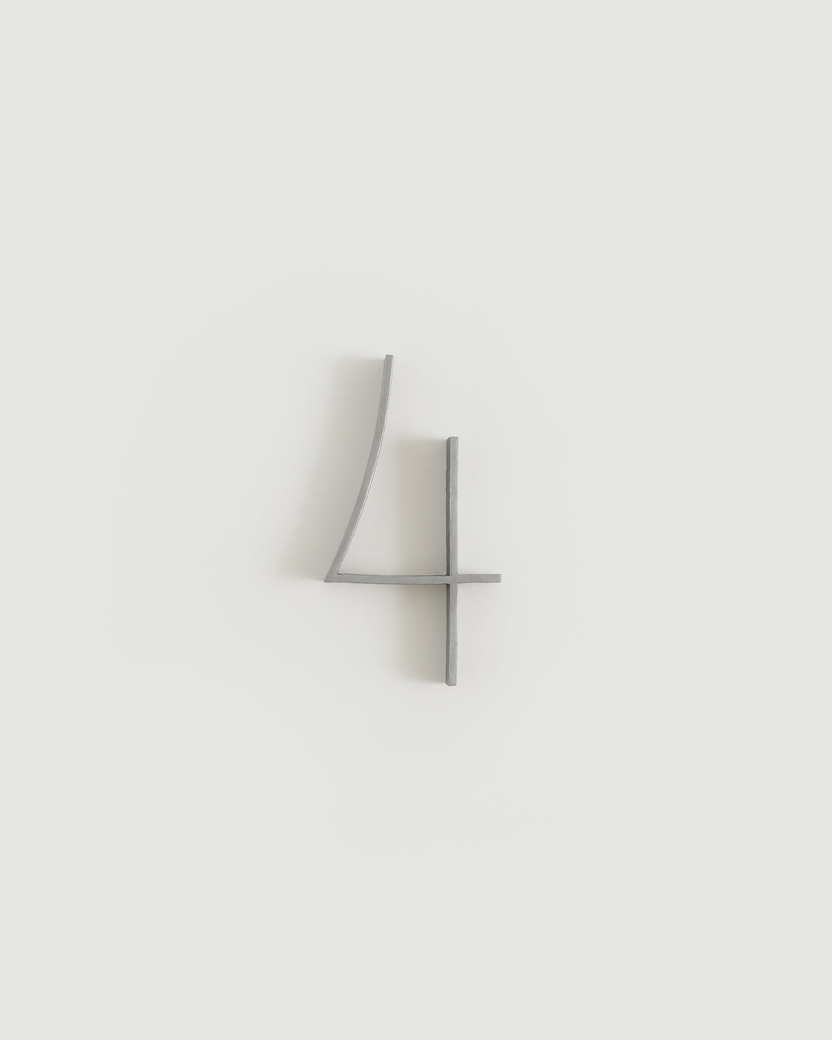 Worn silver house number four