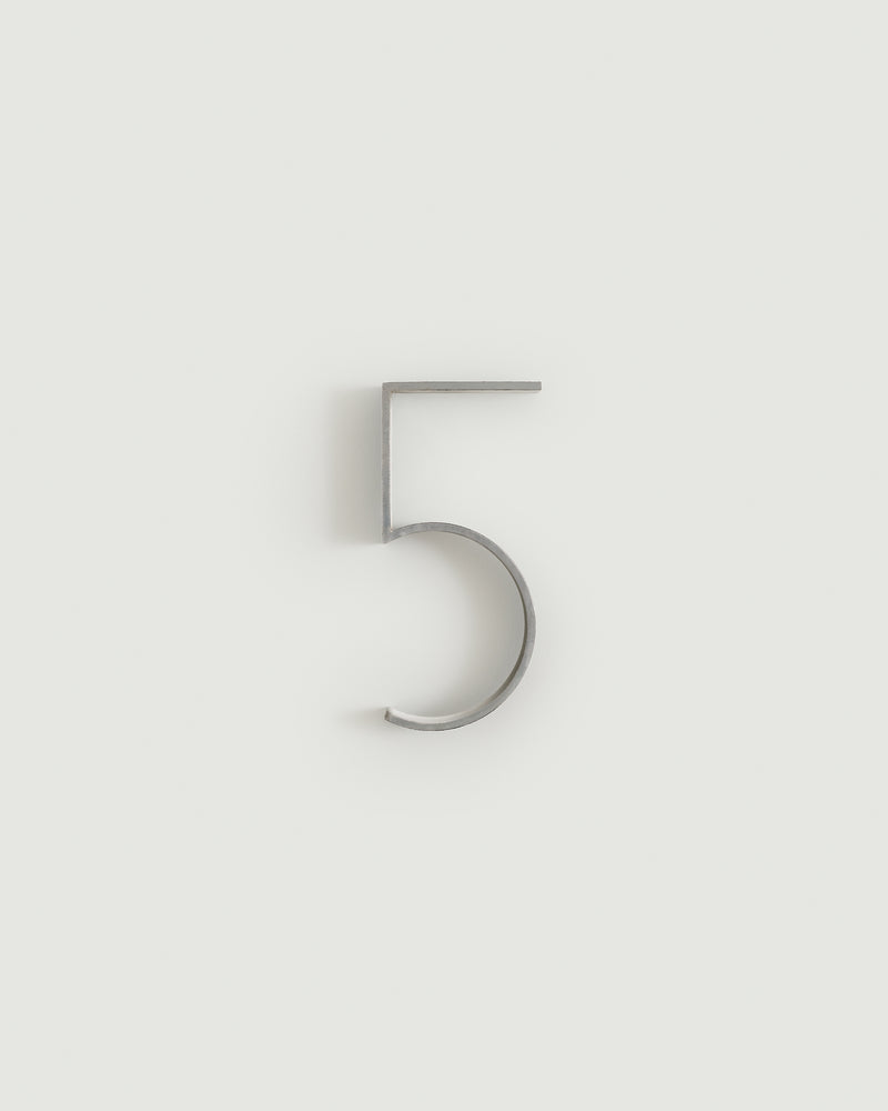 Worn silver house number five