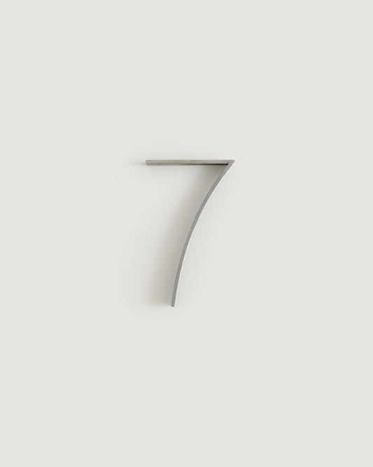 Worn silver house number seven