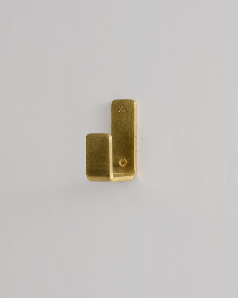 Gold metal bracket on a light gray background