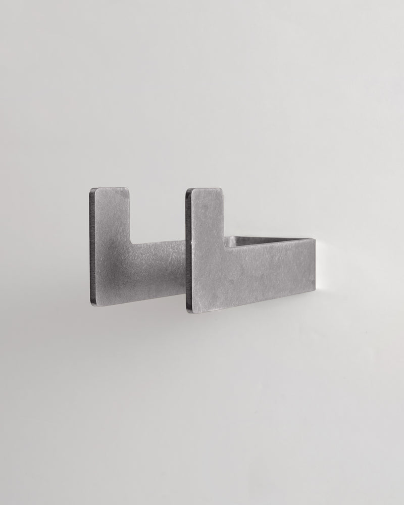 Medium worn silver utility hook on a light gray background