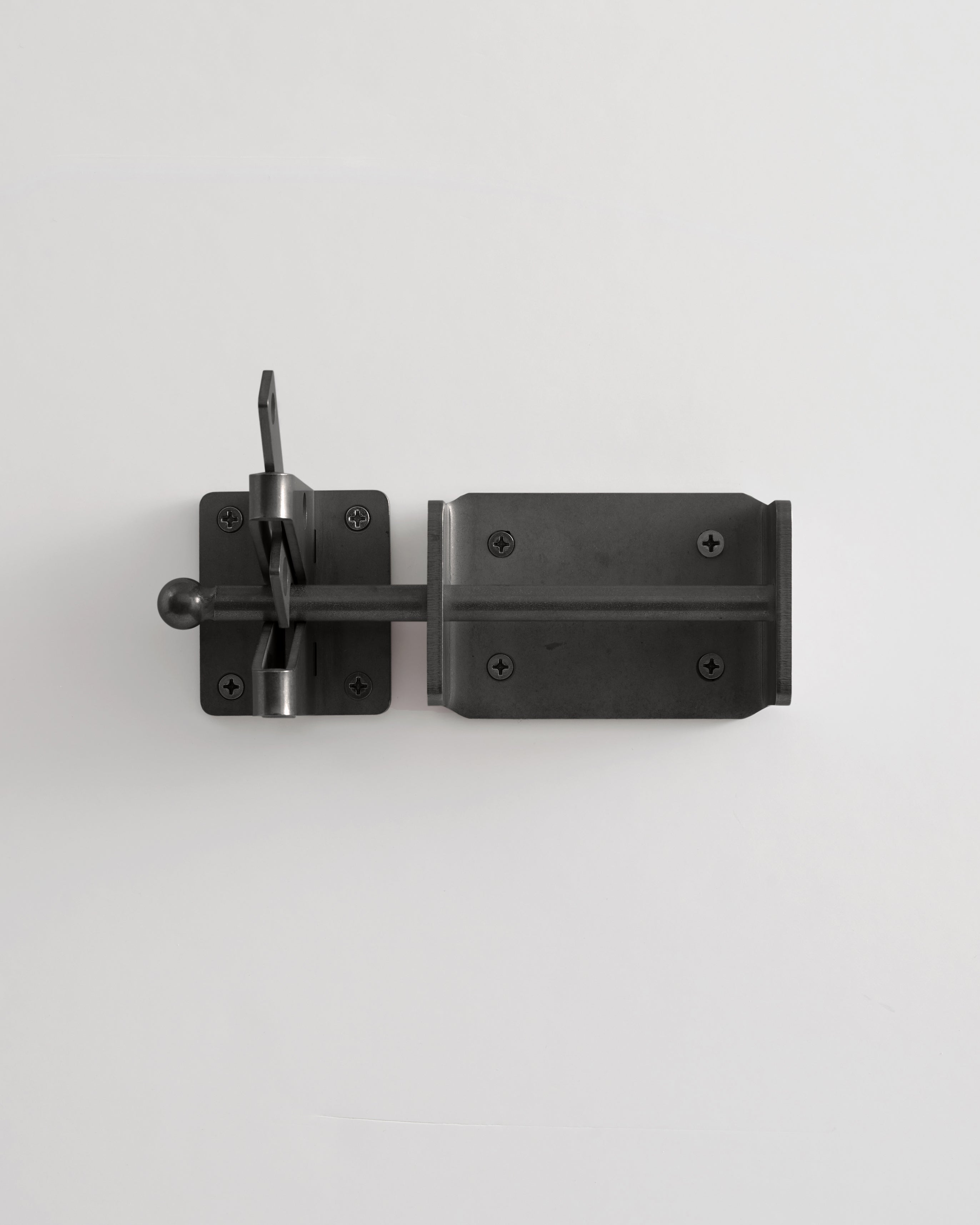 Black metal door latch on a white background