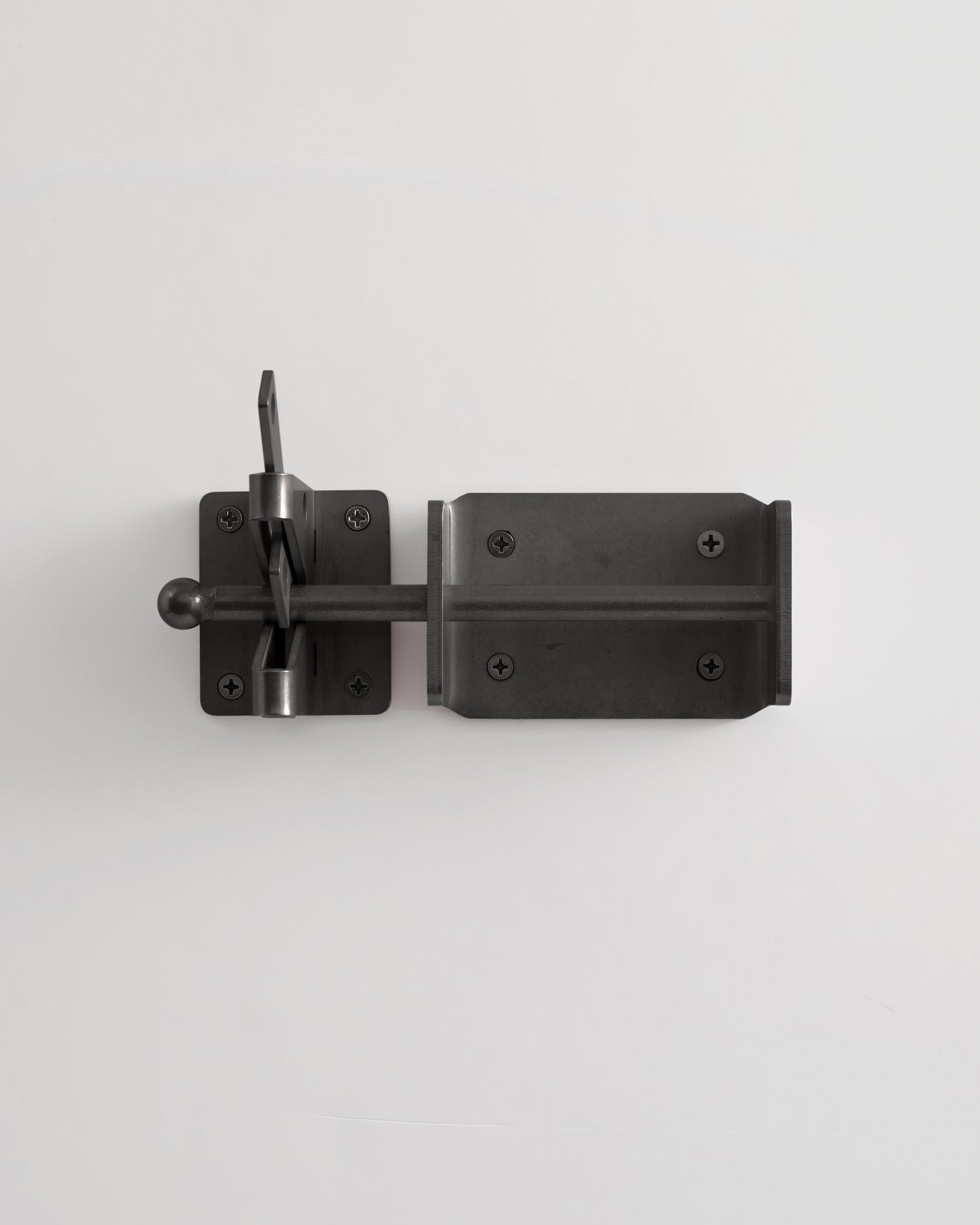 Black metal door latch on a white background