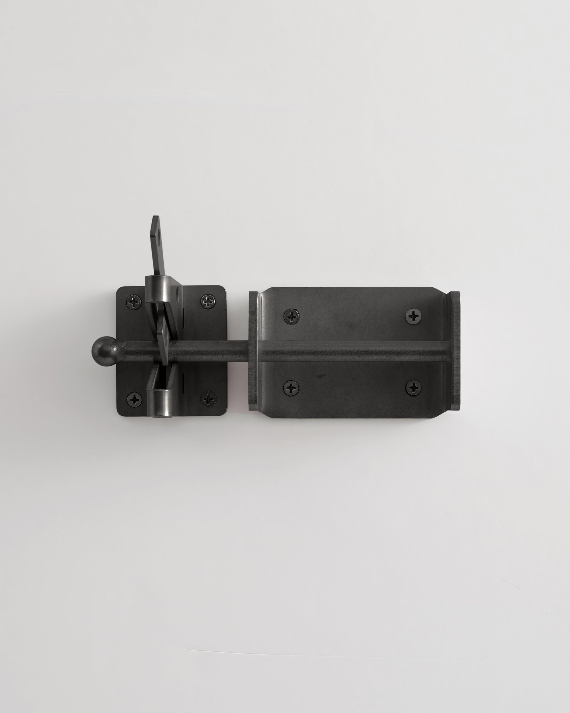 Black metal door latch on a white background