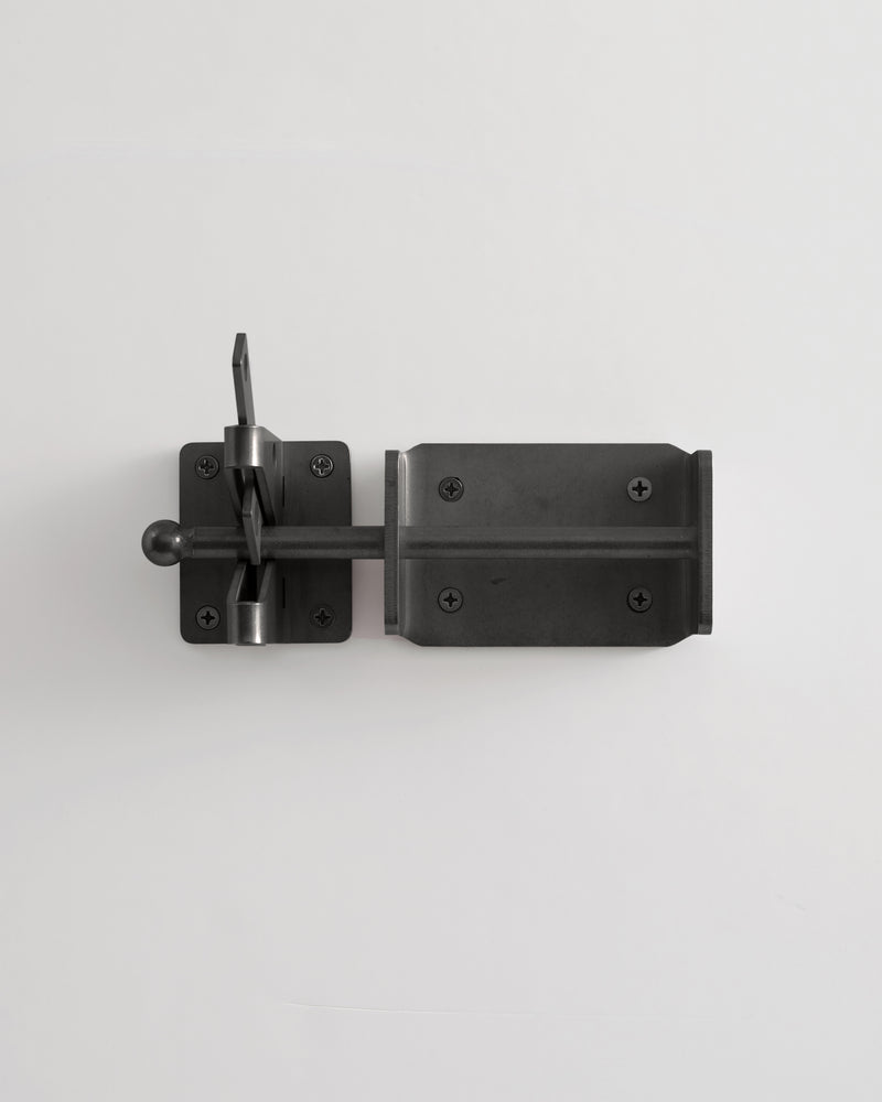Black metal door latch on a white background