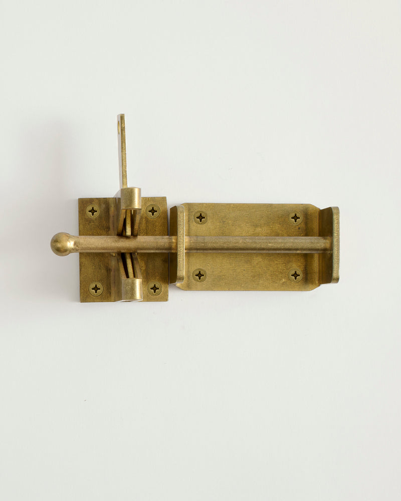 Brass door latch on a white background